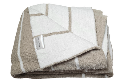 Ultraplush Nest throw blanket in double thickness, draped elegantly over driftwood, showcasing its luxurious softness and durability. Folded to show it's extra thick material and double size