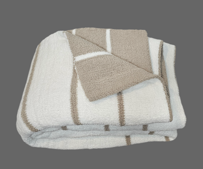 Ultraplush Nest throw blanket in double thickness, folded to show the doubled sided colors. showcasing its luxurious softness and durability.