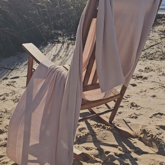 The drift throw in beige almond color, lightweight throw over rocking chair blowing in the beach breeze, oversized throw, travel throw, outdoor throw blanket, easy clean throw, durable bedding