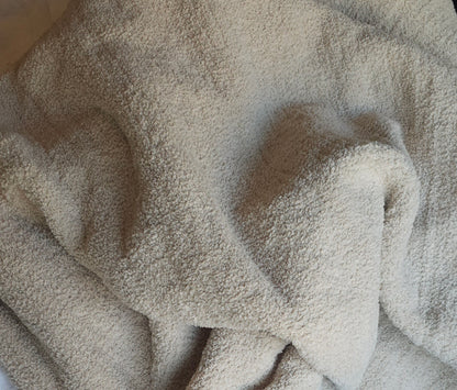 Close up ofNeutral-toned Sand Nest throw, showing off its ultra-soft material and timeless elegance